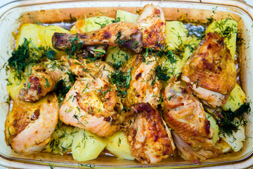 grilled chicken meat with potatoes sprinkled with greens