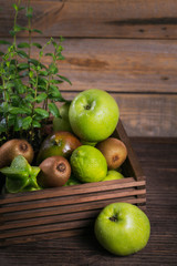 Set of green fruits for healthy diet and detox: apple, lime, kiwi, mango, carambola and mint.