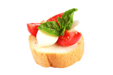 Bruschetta with mozzarella, tomatoes and basil leafs isolated on white background