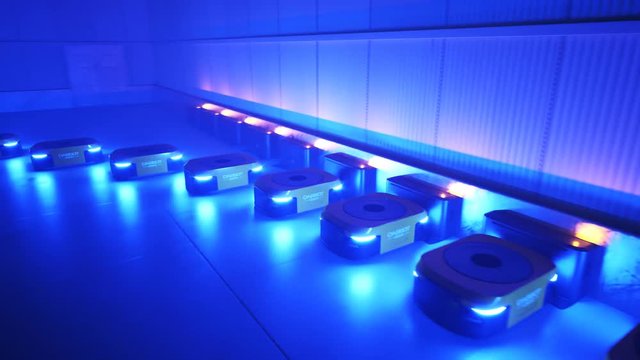 Animation with a warehouse industry autonomic robots starts work after charging