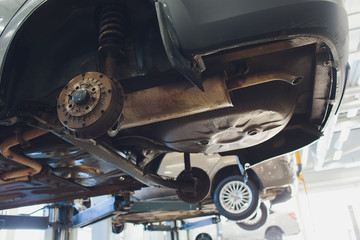 Car raised on car lift in autoservice.