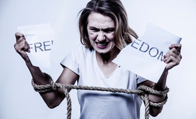 Bound woman's hands as symbol of desire for freedom. Struggle, tension, independence, pain concept.