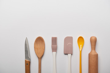 top view of cooking utensils on grey background with copy space