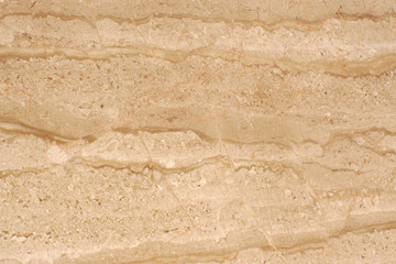 Beige marble with striped patterns on the surface, called Travertino Alabastrino