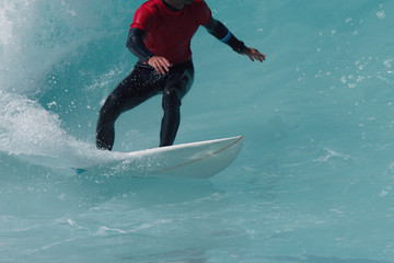 Sports man surfing wave on surfboard in ocean