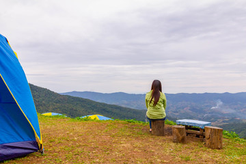 alone lady feel relax and look out mountain view in camping