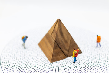 Miniature people: Tourists walk on the maze map, with a graph showing the top.Image use for tourism campaign, spending money, holiday concept.
