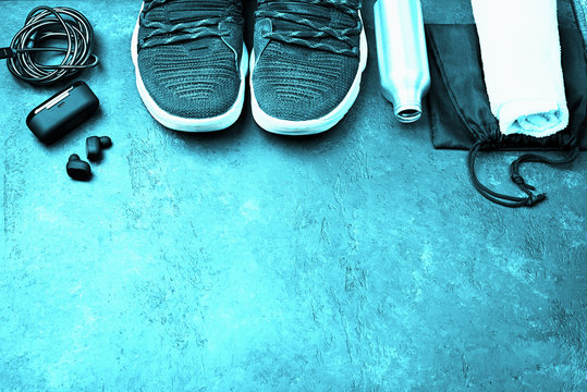 Sports athlete sneakers, headphones, water bottle, watch. Sport concept with processing and tinting