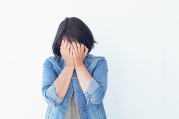 Portrait of young woman hide her eyes over white background