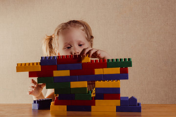 little girl enthusiastically playing constructor