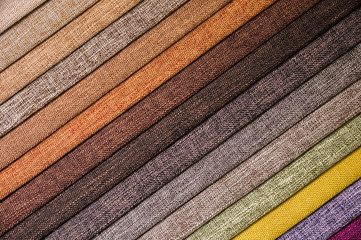 Colorful and bright fabric samples of furniture and clothing upholstery. Close-up of a palette of...