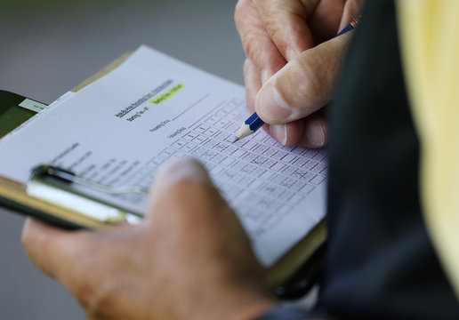 A golfer checks his scorecard during a tournament