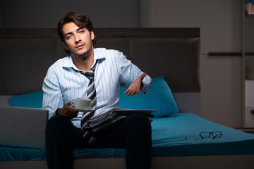 Tired businessman working overtime at home at night