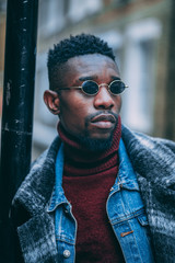 Young fashionable man posing for stylish urban photo shoot 