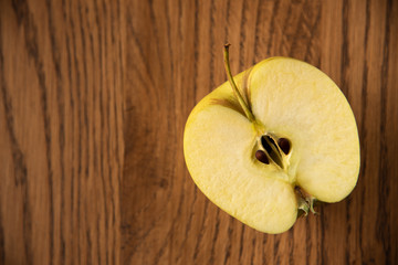 Yellow apple on the wooden vintage background