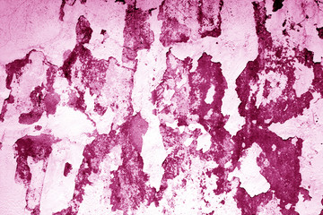 Сraked weathered cement wall texture in pink tone.