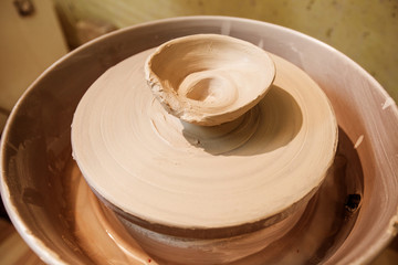 Clay bowl on pottery wheel