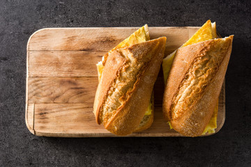 Bocadillo de tortilla española. Spanish potato omelette sandwich on slate background. Top view. Copyspace