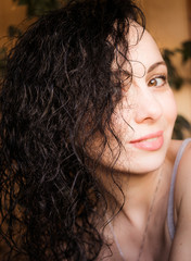 Portrait of young beautiful woman with curly hair