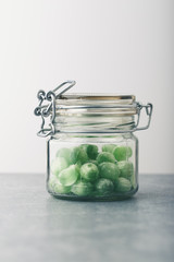 Jar filled with green mint candies on table