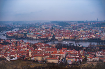 View of the red roofs, Vltava and bridges in Prague. Stare Misto and Mala Strana. Overcast weather