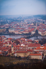 View of the red roofs, Vltava and bridges in Prague. Stare Misto and Mala Strana. Overcast weather