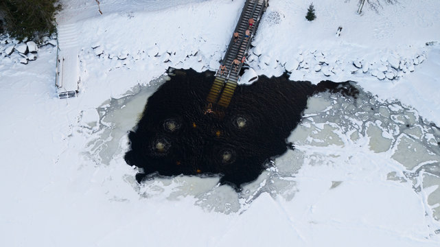 Group Of People Swimming In Ice Hole In The Lake. FInand