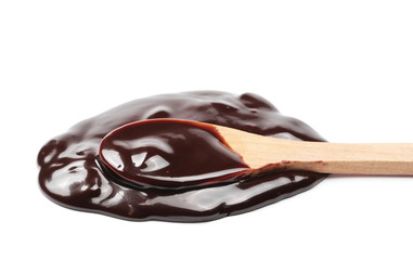 Melted chocolate for topping with wooden spoon isolated on white background, clipping path