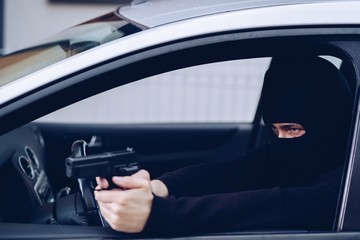 Masked terrorist with pistol gun