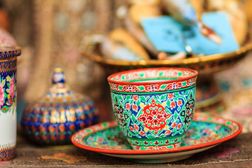 Vintage Thai's style porcelain coffee cup handmade. Beautiful traditional Thai five-colored porcelain ceramic coffee cup. Benjarong Porcelain coffee cup for sale in the flea market, Thailand.