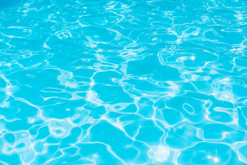 Fototapeta na wymiar Blue water in pool for background and abstract, Ripple wave with sun reflection in swimming pool, Clean and bright purified water for healthy swimming