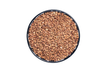 Vegetable food. Macro of a bowl of uncooked raw brown buckwheat grains isolated on a white background. Healthy eating. Top view with space for product montage.