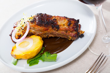 Grilled pork ribs with chocolate sauce and baked potatoes