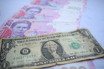 Banknote in one dollar and Ukrainian 200 hryvnia