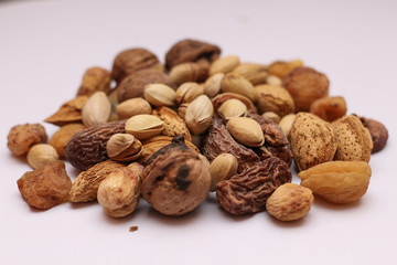 Shot of different dry fruits with white background in a studio