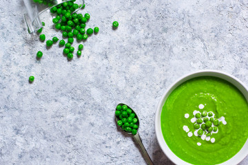 Green peas cream soup, light background, top view 