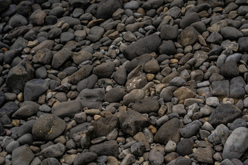 stone texture background with some ocean in the frame, stone background image, rocks at the ocean of New Zealand