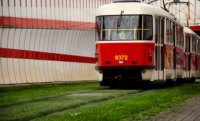 red tramat the stop in the city