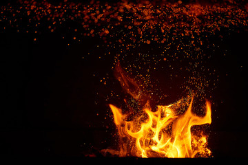 Fototapeta na wymiar Fire flames and sparks on black background