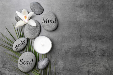 Spa stones and beautiful flower on grey background
