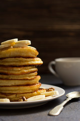 pancakes with honey and nuts, a cup of tea, breakfast, dark background