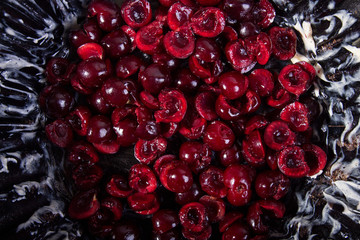 Preparing clafouti swett cherry cake, pie. Buttered cake pan with prepared fruits. Top view.