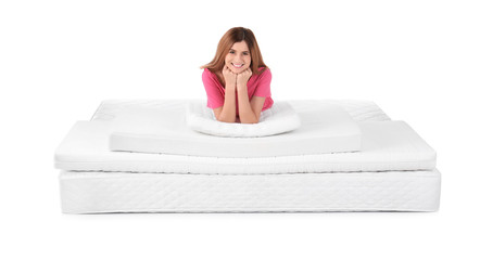 Woman lying on mattress pile against white background