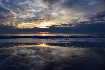 Dramatic reflection of clouds at sunset