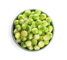 Bowl of fresh Brussels sprouts isolated on white, top view