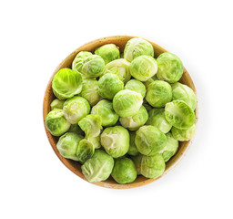 Bowl of fresh Brussels sprouts isolated on white, top view