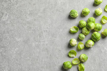 Fresh Brussels sprouts on grey background, top view with space for text