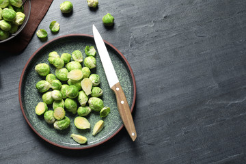 Plate with fresh Brussels sprouts on table, top view. Space for text