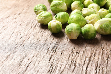 Fresh Brussels sprouts on wooden table, closeup. Space for text
