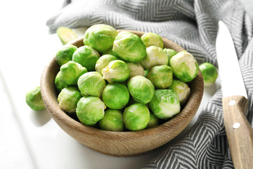 Bowl with fresh Brussels sprouts on table